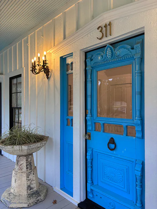 Blue panelled entrance door of a boutique guesthouse