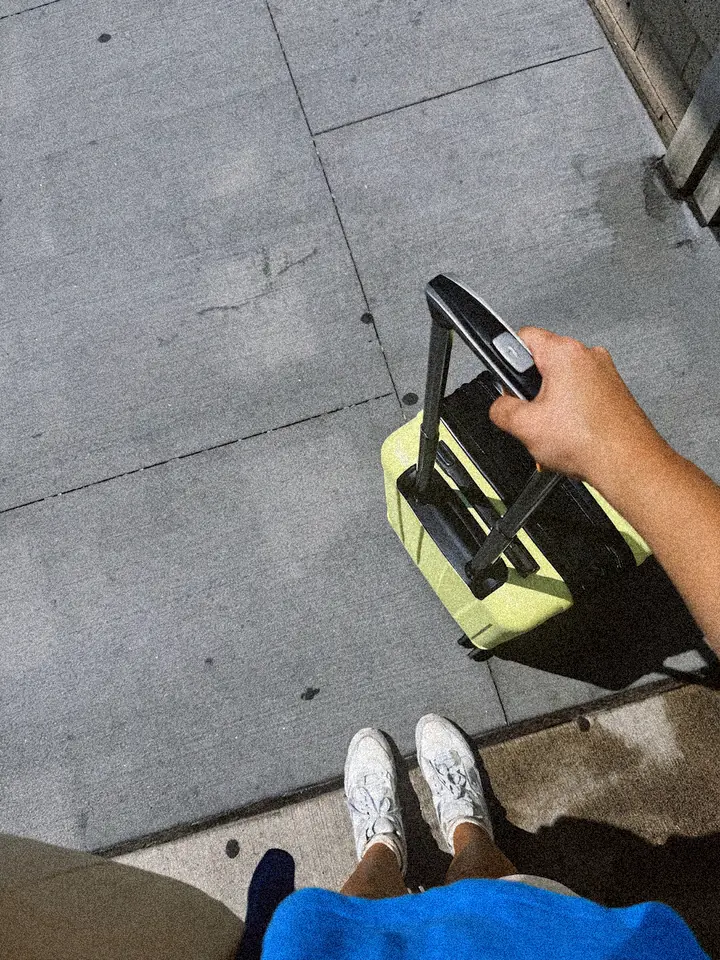 Guest arriving with a suitcase on the pavement