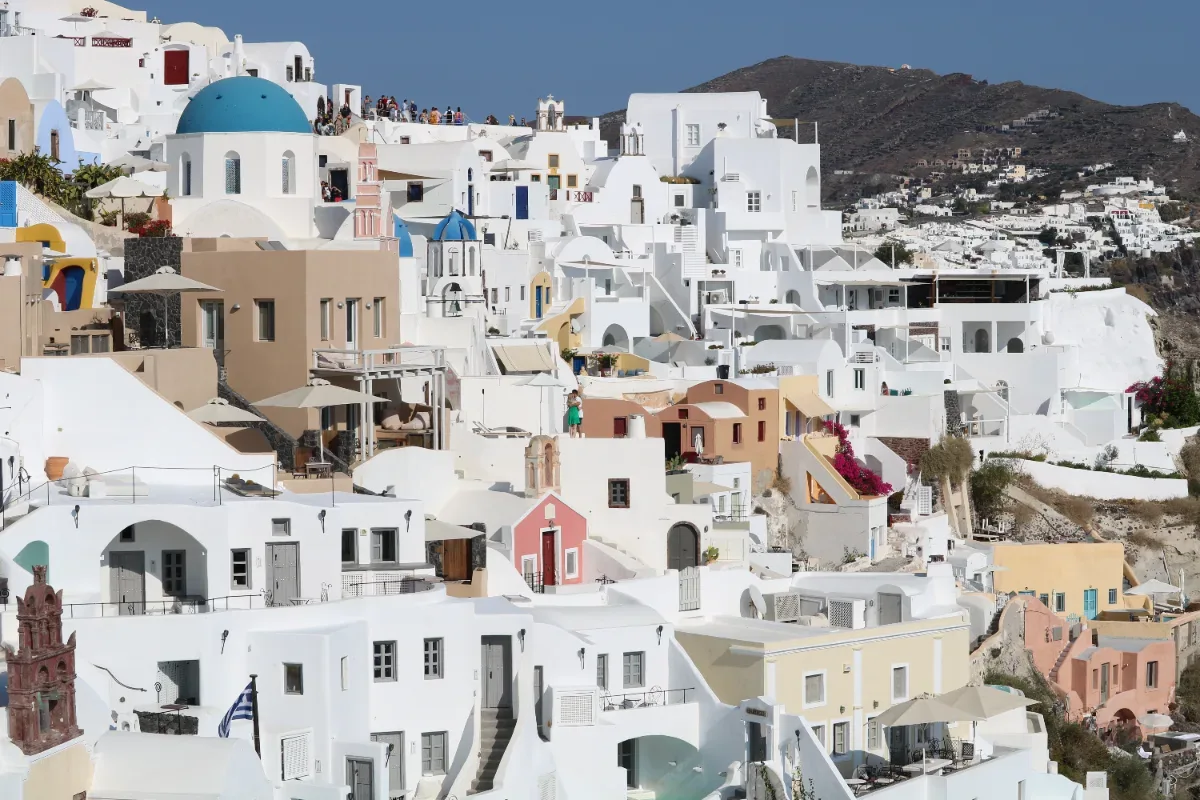 Whitewashed Santorini village cascading down the hillside above the caldera