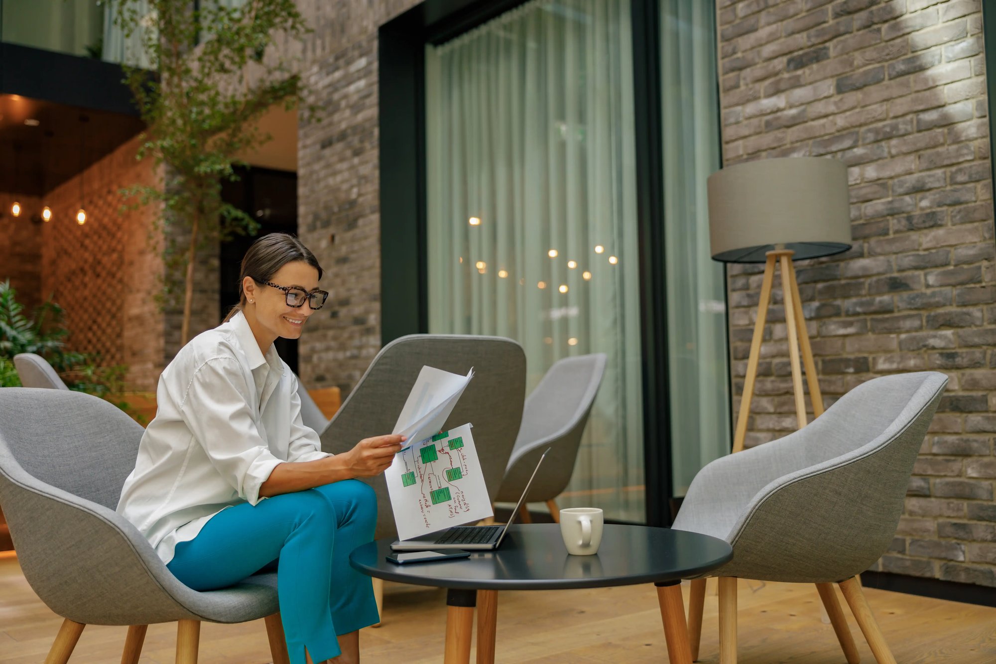 smiling-female-financier-working-with-documents-an-2025-03-09-15-20-12-utc smiling-female-financier-working-with-documents-an-2025-03-09-15-20-12-utc