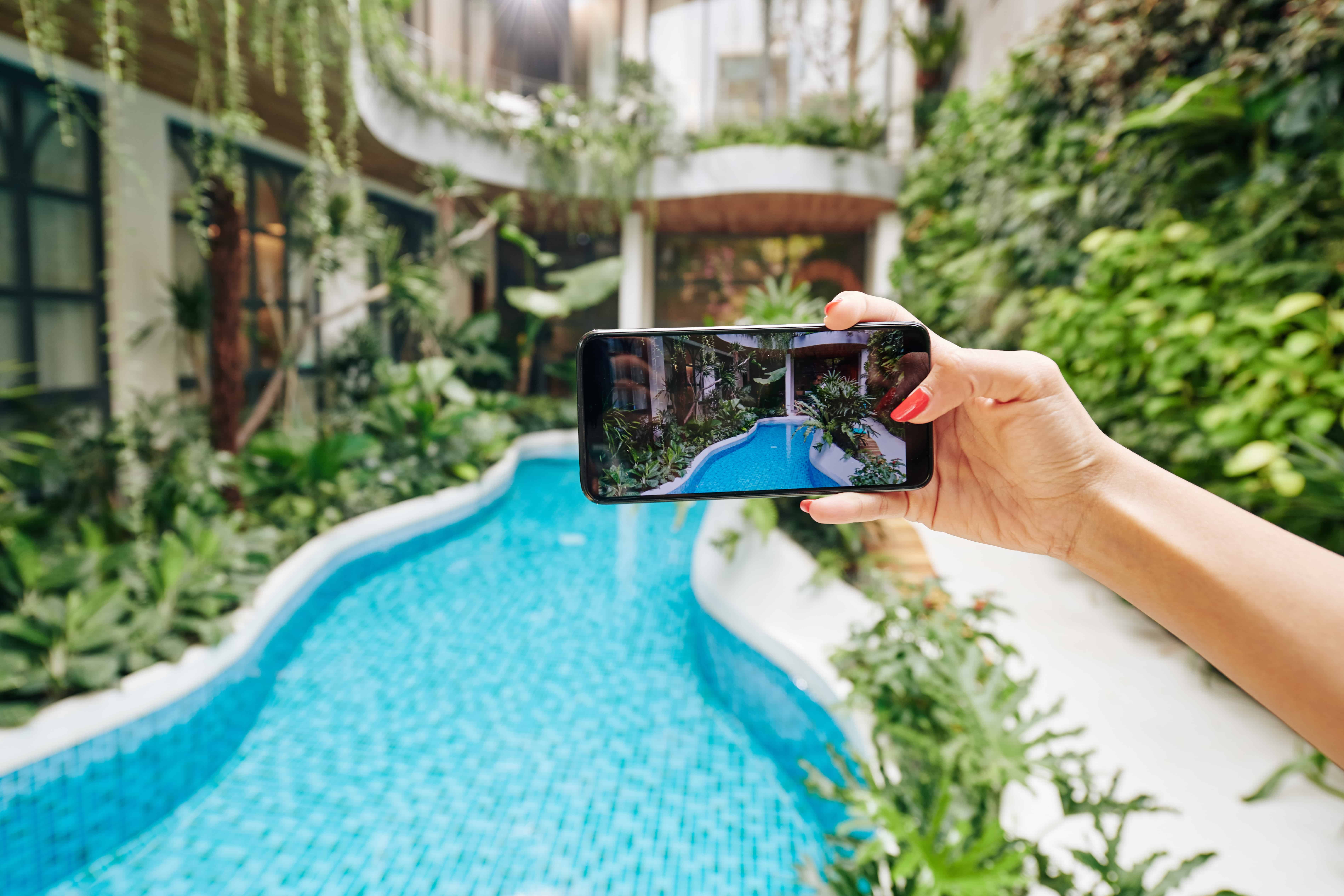 woman-photographing-swimming-pool-2023-11-27-05-31-22-utc-min