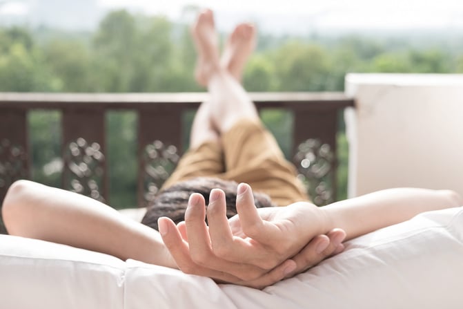 young-man-relax-bed-enjoying-mountain-view