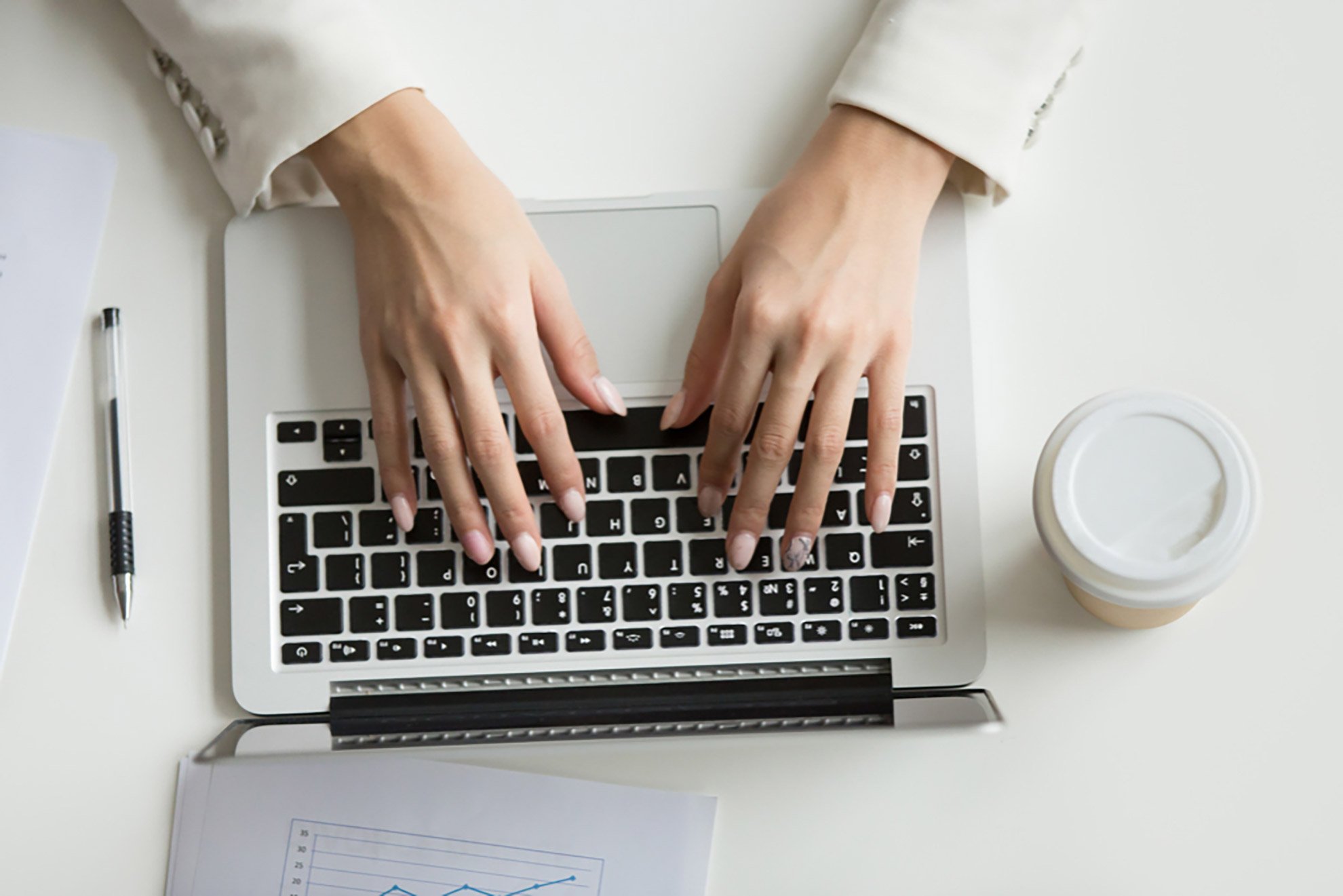 businesswoman-working-laptop-hands-typing-keyboard-top-view