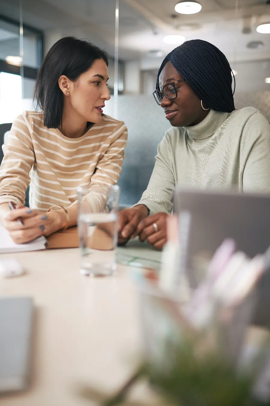 women-chatting-holding-papers