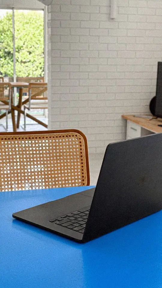 Laptop open on a blue desk