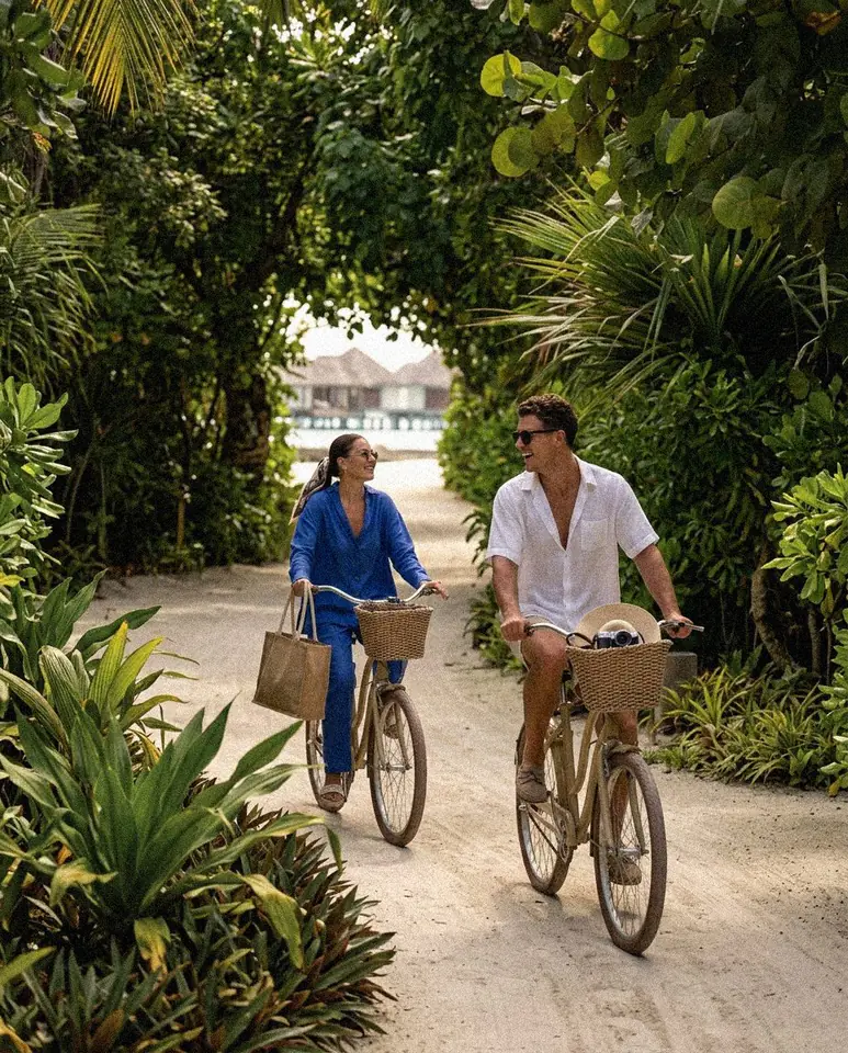 Guests cycling through a resort garden